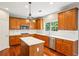 Kitchen with wood cabinets, a white subway tile backsplash, stainless steel appliances, and a kitchen island at 2848 Stockbridge Way, Dacula, GA 30019
