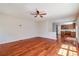Living room featuring hardwood floors and a ceiling fan, conveniently situated next to the kitchen at 2848 Stockbridge Way, Dacula, GA 30019