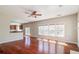 Bright living room with hardwood floors, ceiling fan, and large windows offering natural light at 2848 Stockbridge Way, Dacula, GA 30019