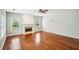 Spacious living room with hardwood floors, a decorative fireplace, and large windows providing ample natural light at 2848 Stockbridge Way, Dacula, GA 30019