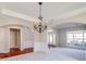 Open living room with a chandelier, lots of natural light and hardwood floors at 2848 Stockbridge Way, Dacula, GA 30019