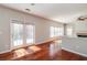 Bright living room with hardwood floors, a fireplace, and sliding glass doors to the yard at 2848 Stockbridge Way, Dacula, GA 30019