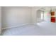 Open-concept living area with neutral carpet and a glimpse of the dining area at 2848 Stockbridge Way, Dacula, GA 30019