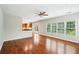 Bright living room featuring hardwood floors, ceiling fan, and a view of the backyard at 2848 Stockbridge Way, Dacula, GA 30019