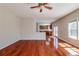 Open-concept living room featuring hardwood floors, a ceiling fan, and easy access to the kitchen at 2848 Stockbridge Way, Dacula, GA 30019