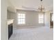 Main bedroom with a decorative ceiling, a fireplace, plush carpet and an ensuite bath at 2848 Stockbridge Way, Dacula, GA 30019