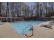 View of the neighborhood pool featuring lounge chairs and mature shade trees at 2848 Stockbridge Way, Dacula, GA 30019
