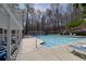 Community pool and pool house features lounge chairs at 2848 Stockbridge Way, Dacula, GA 30019