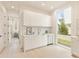 Modern kitchen featuring white cabinets, stainless steel appliances, and a large window with a view of the backyard at 370 2Nd St, Fayetteville, GA 30214