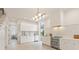 Modern all-white kitchen with stainless steel appliances, marble backsplash, and contemporary lighting at 370 2Nd St, Fayetteville, GA 30214