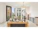 Bright living room features stylish furnishings, large windows overlooking landscaped yard, and light wood flooring at 370 2Nd St, Fayetteville, GA 30214