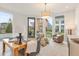 Sunlit living room with contemporary furnishings, large windows showcasing lush landscaping, and hardwood floors at 370 2Nd St, Fayetteville, GA 30214