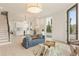 Bright open-concept living space featuring a modern kitchen, wood floors, and stylish staircase at 370 2Nd St, Fayetteville, GA 30214