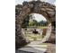 Outdoor space with stone archway, a fire pit, stone walkway, and natural setting at 370 2Nd St, Fayetteville, GA 30214