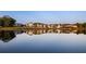 Picturesque waterfront view of homes reflected in calm water, showcasing a peaceful community at 370 2Nd St, Fayetteville, GA 30214
