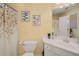 Charming bathroom features a white vanity, framed artwork, and floral shower curtain at 5114 Parkwood Oaks Ln, Mableton, GA 30126