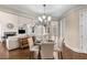 Breakfast nook with chandelier, seating, and open views of the living room and staircase at 5114 Parkwood Oaks Ln, Mableton, GA 30126