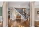 Elegant foyer featuring hardwood floors, staircase with iron railings, and detailed trim work at 5114 Parkwood Oaks Ln, Mableton, GA 30126
