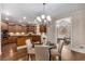 Gourmet kitchen, breakfast area with hardwood floors, wooden cabinets, and chandelier lighting at 5114 Parkwood Oaks Ln, Mableton, GA 30126