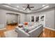 Spacious living room features hardwood floors, a ceiling fan, and a large sectional sofa for relaxation and comfort at 5114 Parkwood Oaks Ln, Mableton, GA 30126