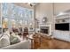 Living room with a stone fireplace, built-in shelves, and oversized windows showcasing the backyard at 5114 Parkwood Oaks Ln, Mableton, GA 30126