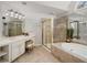 A modern bathroom boasts a stand-up shower, jacuzzi tub, and a large vanity at 5114 Parkwood Oaks Ln, Mableton, GA 30126
