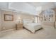 A bright main bedroom features a tray ceiling, a chandelier, and ample natural light at 5114 Parkwood Oaks Ln, Mableton, GA 30126