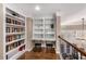A cozy office nook features built-in bookshelves and a workstation near the staircase landing at 5114 Parkwood Oaks Ln, Mableton, GA 30126