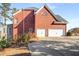 Brick home features an attached garage, a paved driveway, and a well-maintained lawn for curb appeal at 5114 Parkwood Oaks Ln, Mableton, GA 30126