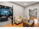 Comfortable sitting area features hardwood floors, a coffee table, and easy access to the home theater at 5114 Parkwood Oaks Ln, Mableton, GA 30126