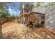 Relax on the wooden deck overlooking the grassy backyard and fence, a perfect spot for outdoor enjoyment at 1830 Marietta Nw Rd, Atlanta, GA 30318