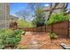 Fenced backyard with lush greenery and a glimpse of a deck, offering a private and peaceful outdoor space at 1830 Marietta Nw Rd, Atlanta, GA 30318