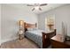 Bedroom with wood-frame bed, ceiling fan, and natural light from window at 1830 Marietta Nw Rd, Atlanta, GA 30318