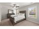 Neutral bedroom features plush carpeting, a ceiling fan, and a window at 1830 Marietta Nw Rd, Atlanta, GA 30318