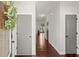Neutral hallway with grey doors and dark hardwood floors, leading to other rooms in the home at 1830 Marietta Nw Rd, Atlanta, GA 30318