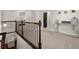 Upstairs hallway featuring wood railing and carpet with a console table and home decor accents at 1830 Marietta Nw Rd, Atlanta, GA 30318
