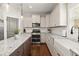 Bright kitchen features granite countertops, white cabinets, and stainless steel appliances at 1830 Marietta Nw Rd, Atlanta, GA 30318