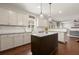 Modern kitchen features a center island, granite countertops, stainless steel appliances, and white subway tile backsplash at 1830 Marietta Nw Rd, Atlanta, GA 30318