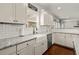 Well-lit kitchen with white subway tile backsplash, stainless steel appliances, and a farmhouse sink at 1830 Marietta Nw Rd, Atlanta, GA 30318