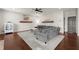 Cozy living room with a large sectional sofa, ceiling fan, hardwood floors, and bright neutral paint at 1830 Marietta Nw Rd, Atlanta, GA 30318