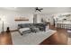 Spacious living room with a gray sectional, hardwood floors, and open concept design at 1830 Marietta Nw Rd, Atlanta, GA 30318