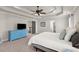 Main bedroom with tray ceiling, ceiling fan, and adjoining bathroom and closet entrances at 1830 Marietta Nw Rd, Atlanta, GA 30318