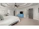 Spacious main bedroom with tray ceiling, fan, neutral tones, and access to ensuite and walk-in closet at 1830 Marietta Nw Rd, Atlanta, GA 30318