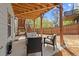 Enjoy the cozy covered patio with string lights, outdoor seating, and steps leading to the upper level at 1830 Marietta Nw Rd, Atlanta, GA 30318