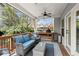 Inviting covered patio with outdoor grill, comfortable seating, and backyard access at 1830 Marietta Nw Rd, Atlanta, GA 30318