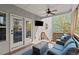 Covered patio with comfortable seating, ceiling fan, and backyard views at 1830 Marietta Nw Rd, Atlanta, GA 30318