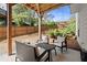 Relax on this covered patio with outdoor seating, surrounded by a lush, fenced backyard and mature landscaping at 1830 Marietta Nw Rd, Atlanta, GA 30318