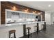 Basement wet bar with marble countertops, seating, and rustic wood details at 1830 Marietta Nw Rd, Atlanta, GA 30318