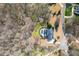Aerial view of a beautiful property with a sparkling pool and lush landscaping in a private wooded setting at 210 Little River Farms Trl, Canton, GA 30115
