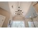 Bright bathroom showcasing a vaulted ceiling, chandelier, shower, and exterior view at 210 Little River Farms Trl, Canton, GA 30115